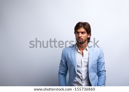 Fashion men, male model wear blue suit, young man with copy space over gray background