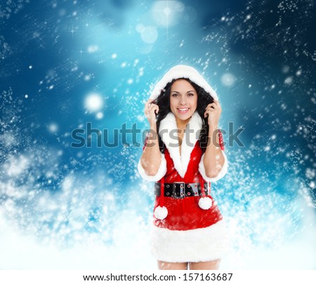 young happy smile woman wear Santa Clause costume, attractive christmas new year party girl looking at camera, over abstract magic blue winter background with sparkles blowing snow