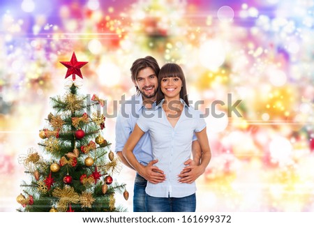 christmas holiday happy couple, new year decorated tree, family man and woman love smile over abstract colorful lights background