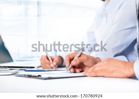 Business people hands writing sign up contract, sitting at desk office write notes. Close up paper signing a business contract, businesspeople holding pens seminar