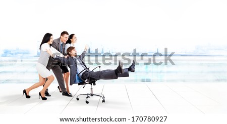 excited business people group team push colleague leader sitting in chair, young businesspeople smile raised hands arms, concept of human resources