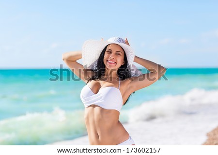 woman smile beach ocean, excited wear white hat and bikini swimsuit, young girl summer vacation holiday on sea enjoying sunny day blue sky