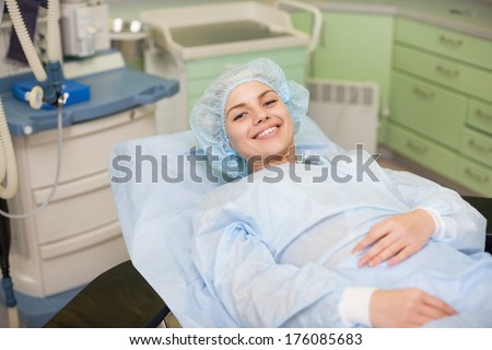 Portrait of beautiful patient lying on bed in surgery room hospital
