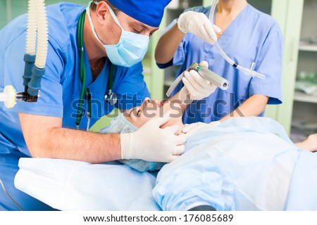 Anesthesiologist Medical Doctor Hold Anesthesia Breathing Mask, Woman Patient Lying In Operating Surgery Room, Hospital Equipment