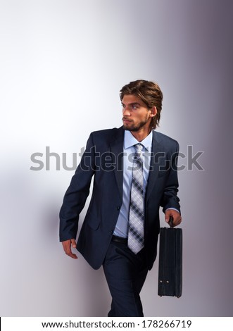 Fashion business man briefcase, Handsome male model wear suit tie, young businessman over gray background