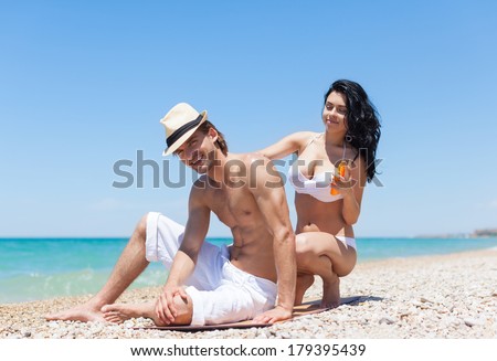woman apply sunscreen protection lotion on man back tanned body, summer beach travel ocean vacation, couple smile applying skin care sun protect