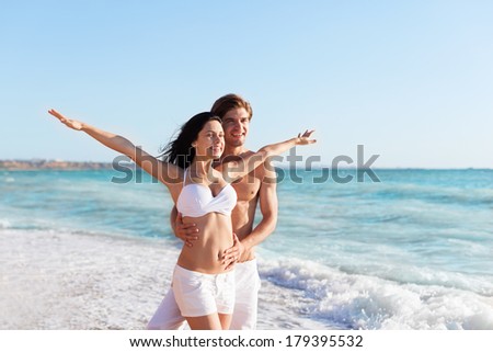Happy couple on beach hold stretching hands, beautiful young happy man and woman love smile, concept summer ocean holiday travel
