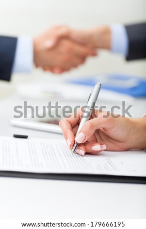 Businesswoman hand sign up contract document at office desk, businessman handshake  during meeting,  business people close up signing agreement