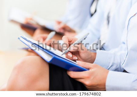 Businesspeople writing hands over papers making notes at seminar, executive businesswoman write on knee sitting at office during business meeting