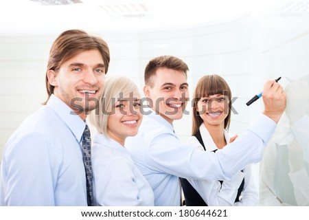 Businesspeople leader explaining draw marker, meeting in board room, businessman explaining colleagues group of business people team in office, conference