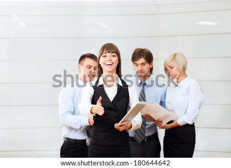 businesswoman handshake, hold hand shake welcome gesture, young excited business woman happy smile at conference hall over group of businesspeople working background, people meeting