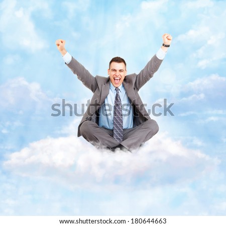 Successful excited business man happy smile hold fist gesture sitting on white cloud with clear blue sky, businessman with raised hands arms, wear suit and tie, concept of success