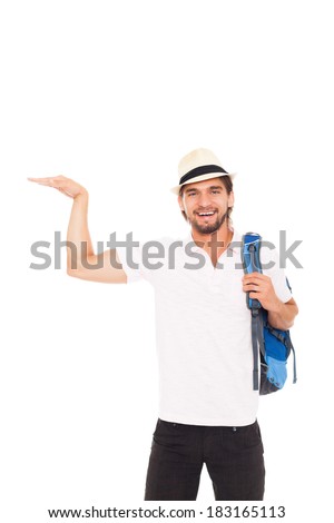 handsome man in hat with backpack show open palm hand gesture with empty copy space, smile, concept of advertise travel summer vacation isolated over white background