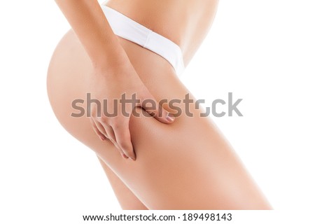 Checking cellulite, woman hip, close up of beautiful female body legs belly, perfect figure isolated over white background