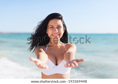 woman excited smile welcome on beach ocean stretched palms hands arms at camera, young girl summer vacation holiday on sea blue sky