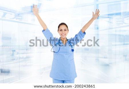excited medical doctor woman happy smile, nurse holding hands arms up wear blue surgery suit in hospital