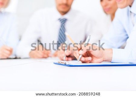 Business people hands writing sign up contract, sitting at desk office write notes. Close up paper signing a business contract, businesspeople holding pens seminar