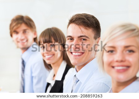 happy smile business woman and man face selective focus, people group in a row, young businesswoman looking at camera, businesspeople team sitting at desk in office