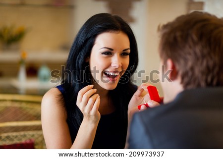 marriage proposal, man give ring to his girl, young happy couple romantic date at restaurant, celebrating valentine day