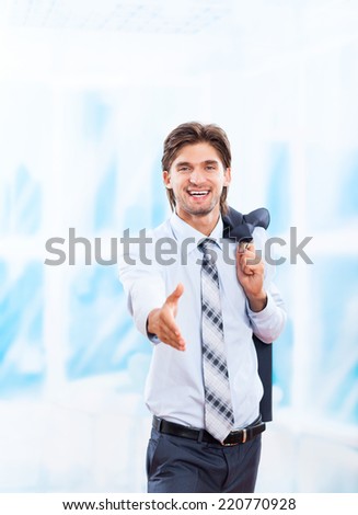 businessman handshake, hold hand welcome gesture in bright blue office, Handsome young excited business man happy smile wear elegant suit and tie