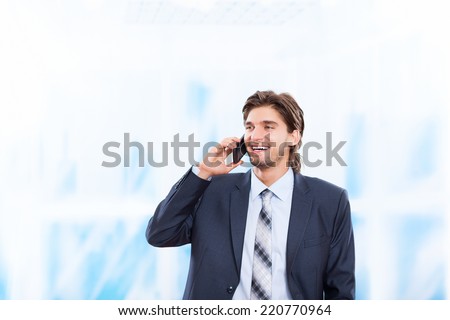 businessman talking on mobile phone in bright blue office, happy smile, using cellphone, handsome young business man phone call, wear elegant suit