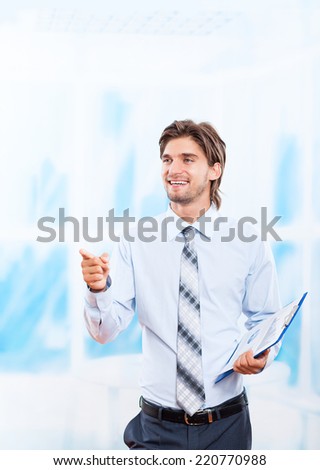 businessman smile point finger pen up to copy space, Handsome young business man with documents, papers, over blue background