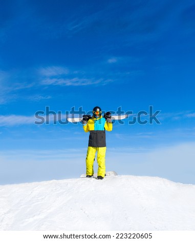 Snowboarder hold snowboard on top of hill, snow mountains snowboarding on slopes