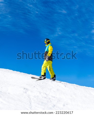 Snowboarder sliding down the hill, snow mountains snowboarding on slopes