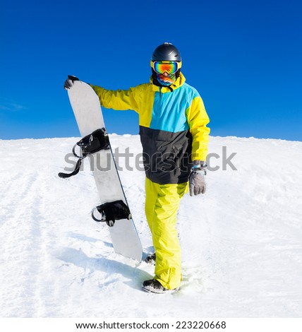Snowboarder hold snowboard on top of hill, snow mountains snowboarding on slopes