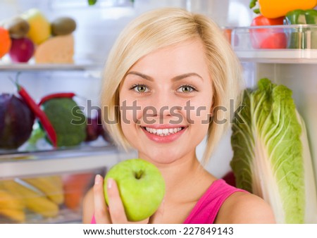 young woman hold fresh green apple smile, refrigerator open door, pretty girl diet healthy vitamin food fruits