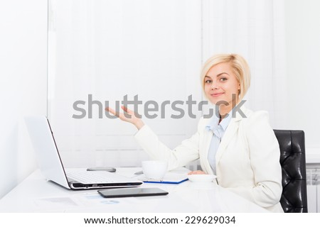 business woman show open palm copy space, businesswoman  sitting in bright modern office desk laptop