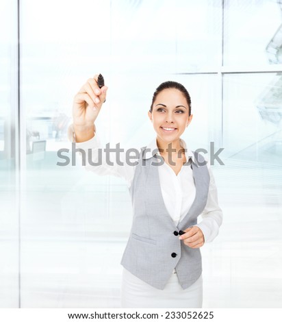 business woman draw concept on copy space, businesswoman point pen at camera, in modern office