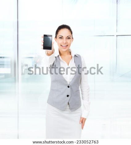 businesswoman displaying mobile cell phone, business woman show touch screen in modern office