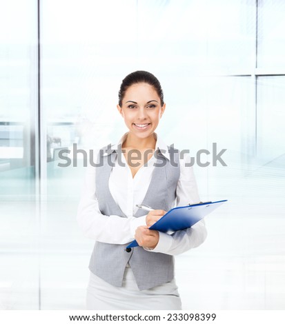 Businesswoman smile, hold blue folder clipboard paper document, young attractive business woman in modern office