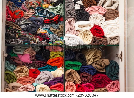 Wardrobe colorful cloth fabric on shelves fashion shop