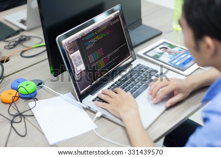 Asian Developer Using Laptop Computer Sitting Working Real Office