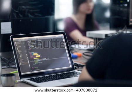 Asian Outsource Developer Team Sitting At Desk Working Laptop Computer Mobile Application Software Real Office