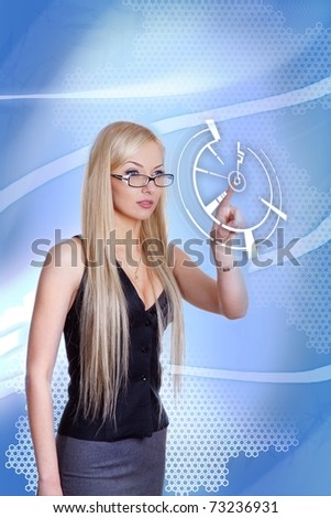 Attractive blonde with interface in futuristic interior (outstanding business people in interiors / interfaces series). Businesswoman pointing her finger on imaginery virtual button.
