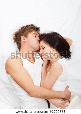 young lovely beautiful couple lying sleeping in a bed, top view.