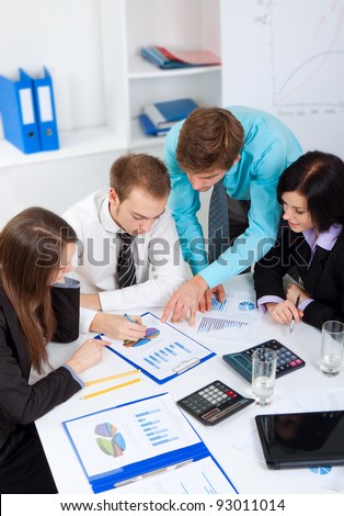 young business people working  on project in team together, men and women discussing the problem, business plan, papers charts, document,  businesspeople meeting sitting at desk office, above top view