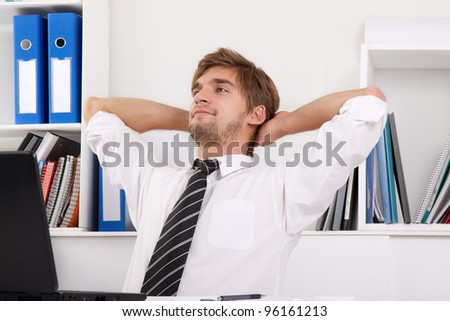 Relaxed young business man happy smile sitting at the desk, handsome businessman relaxing hold hand on head