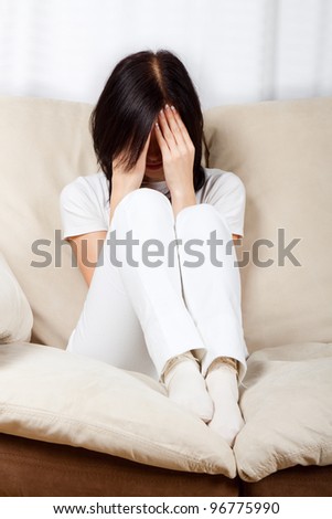 upset woman cry covering her face by hand, concept of young girl depression, stress and problems, pain, female depressed sitting in chair close up face with hands
