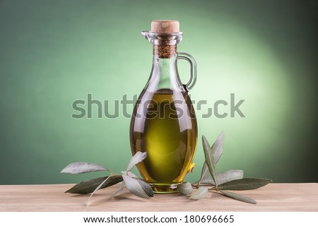 Olive oil  bottle made of glass with a green light spotlight background