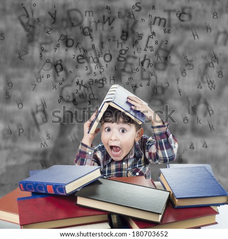 Child against the rain of numbers and letters with a book over his head