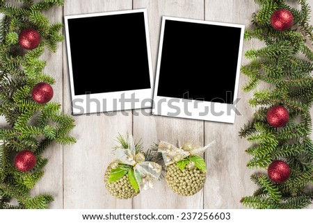Christmas card background with a space for text or photo on an old wooden surface and decorated with fir branches