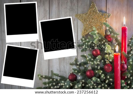 Christmas greeting card with candles and a copy space for text or photo on an old wooden background