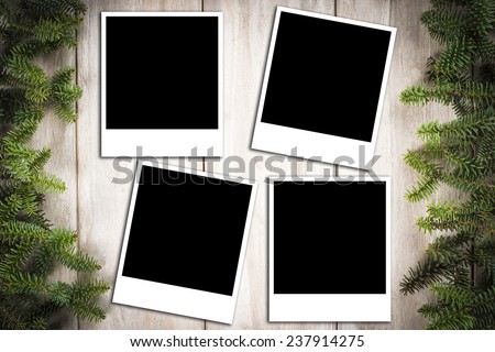 Christmas card background with a space for text or photo on an old wooden surface and decorated with fir branches