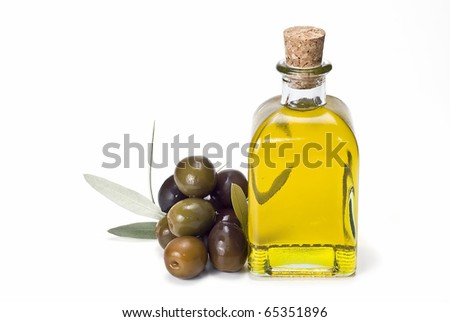A bottle of olive oil and some olives isolated on a white background A bottle of olive oil and some olives isolated on a white background