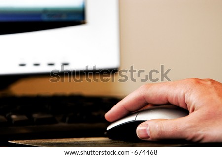Man's hand using a computer mouse - work, school, surfing the internet, etc.