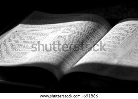 Black and White image of a family Bible in sunlight and shade, opened to Matthew Chapter 2 ~ The 3 wise men come to worship Jesus.
